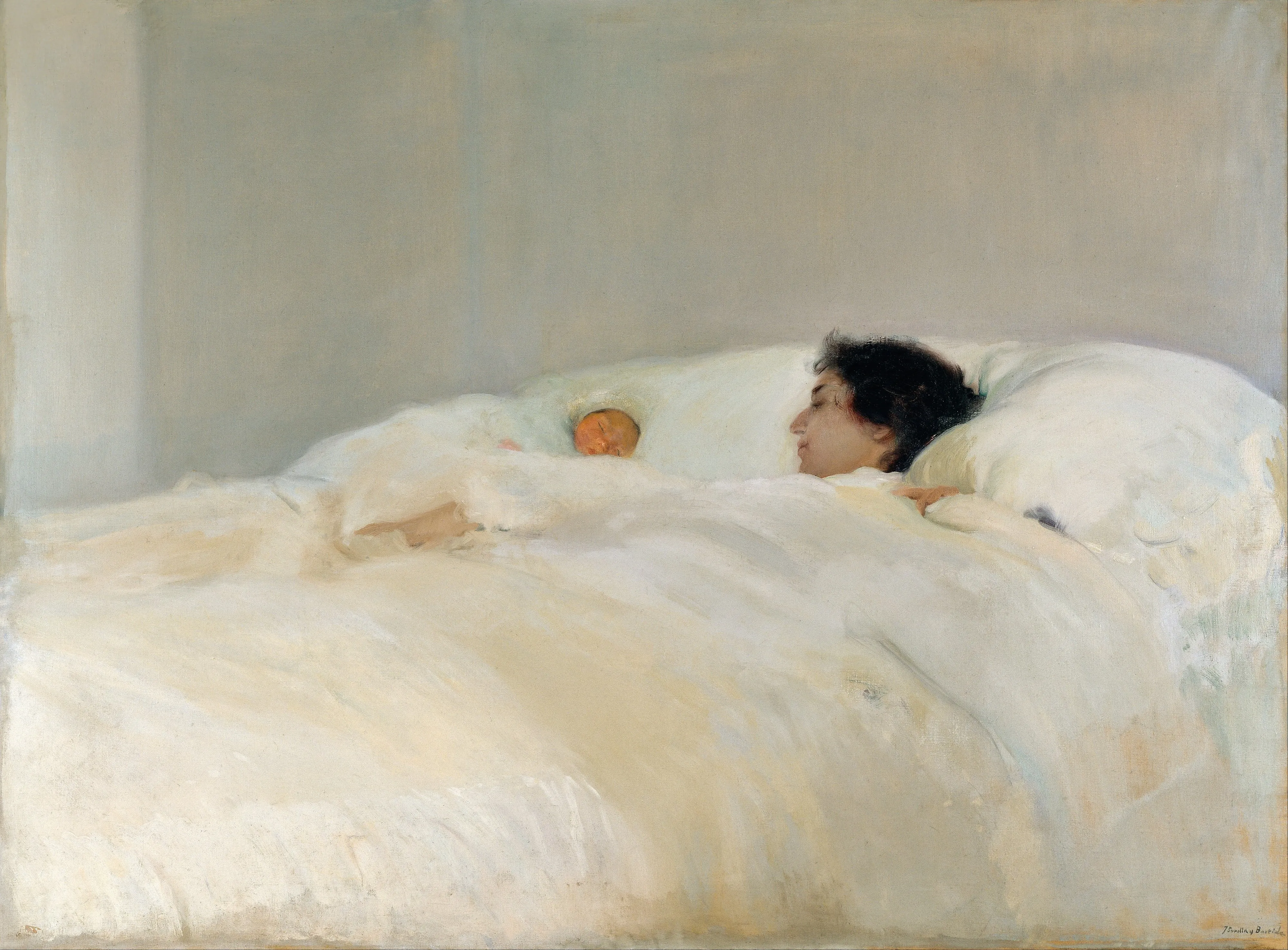 A mother rests in a bed of white sheets and pillows beside her swaddled newborn, the near-monochrome whites modulated by the softest light.