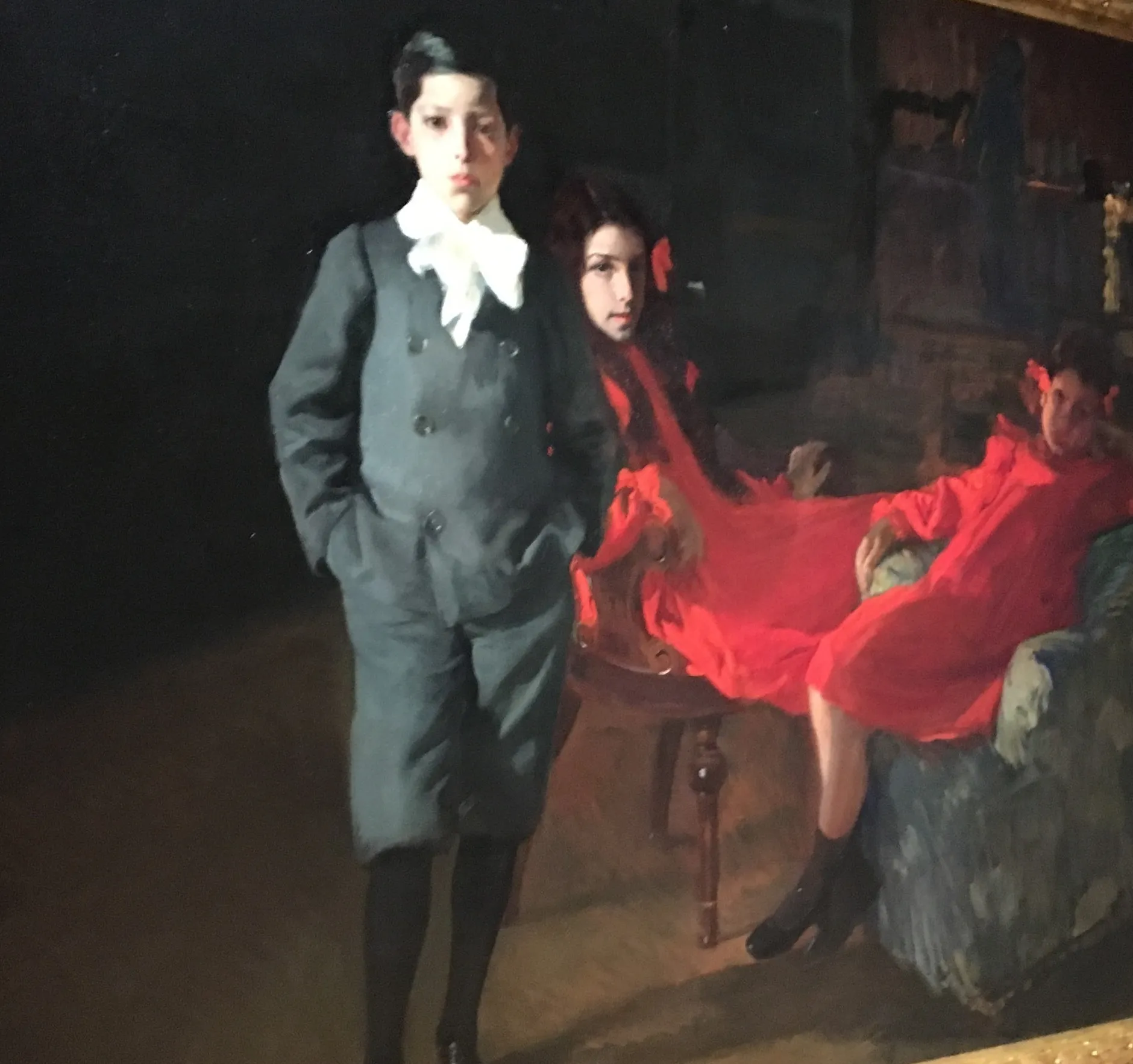 Sorolla's three children pose together in an affectionate family portrait, their faces and white clothes softly modelled in gentle light.