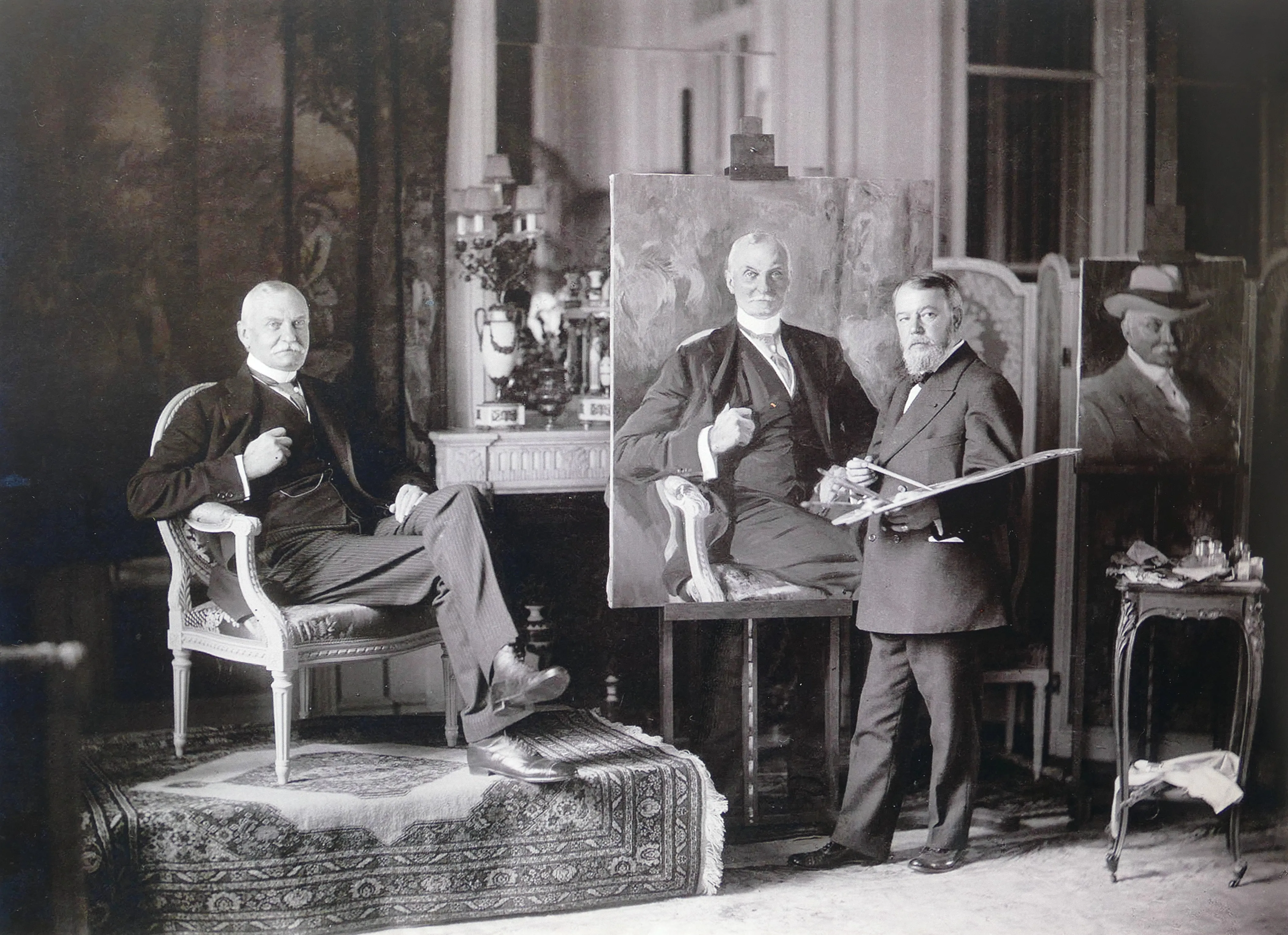 Photograph of Joaquín Sorolla in his studio painting a seated portrait of Mr Ryan, 1913