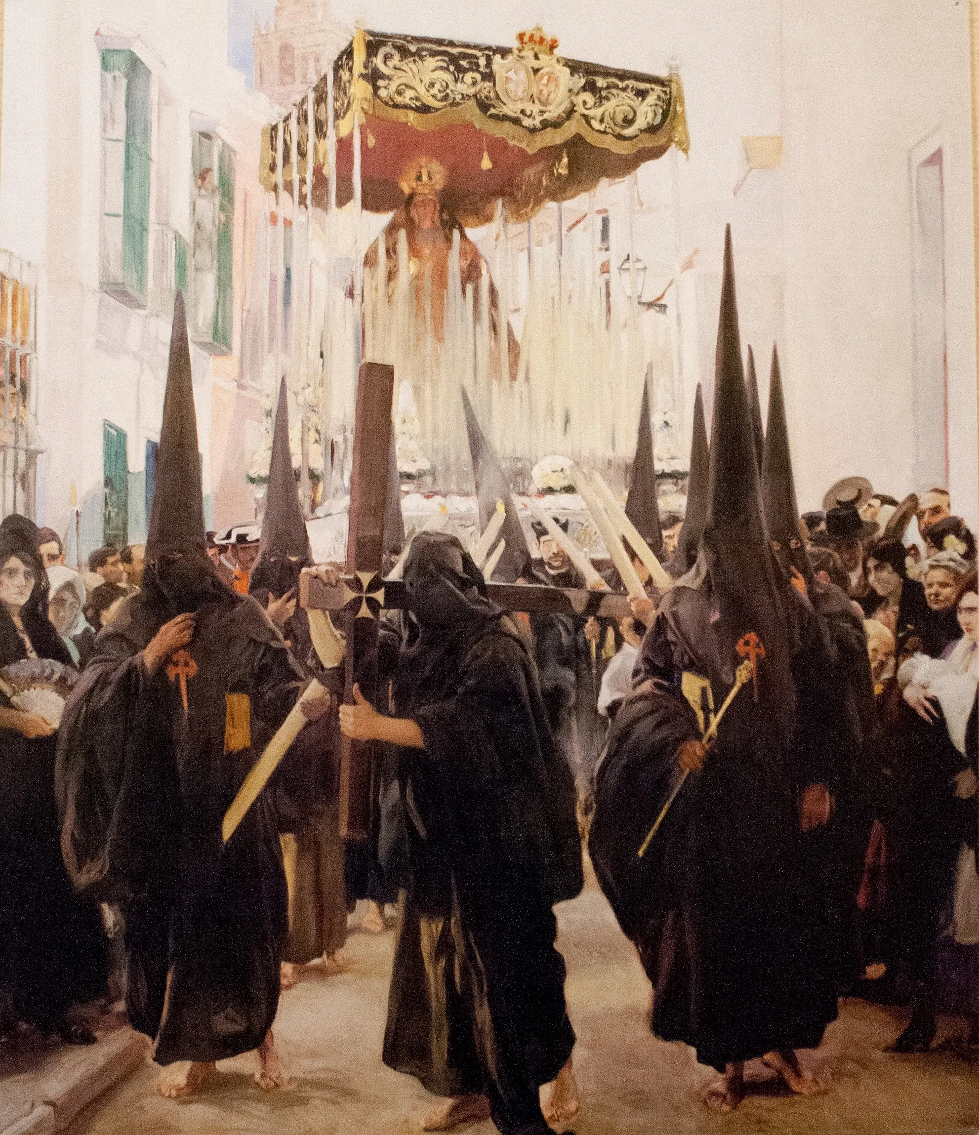 A solemn Holy Week procession in Seville, robed penitents and a canopied image moving through the crowd under a warm sky.